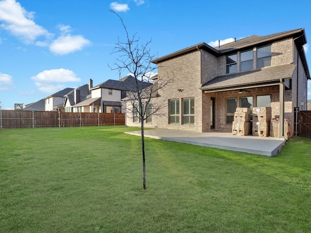 back of house featuring a lawn, a patio area, and ceiling fan