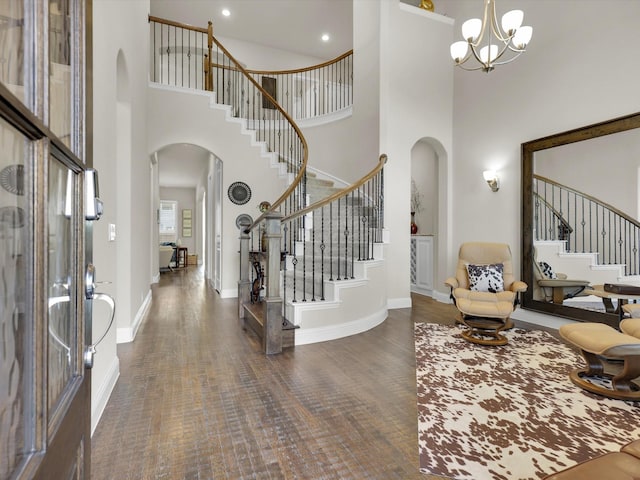 foyer with a chandelier, a high ceiling, and dark hardwood / wood-style floors