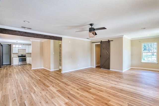 unfurnished living room with ceiling fan, light hardwood / wood-style flooring, crown molding, and a barn door