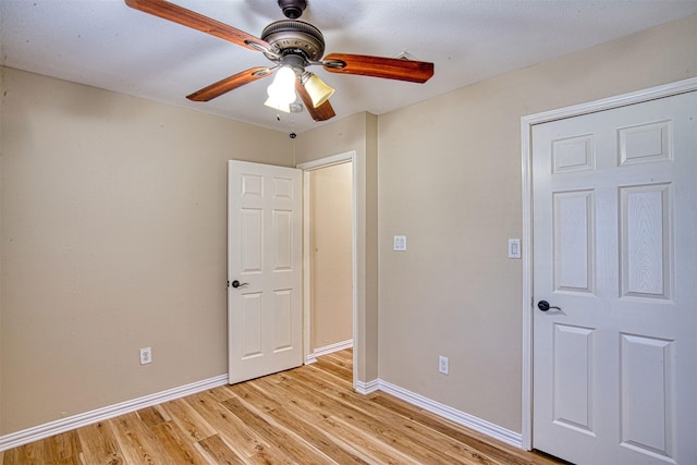 unfurnished bedroom with ceiling fan and light hardwood / wood-style flooring