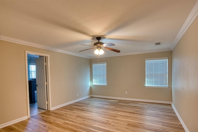 unfurnished room featuring ceiling fan, light wood-type flooring, crown molding, and a textured ceiling