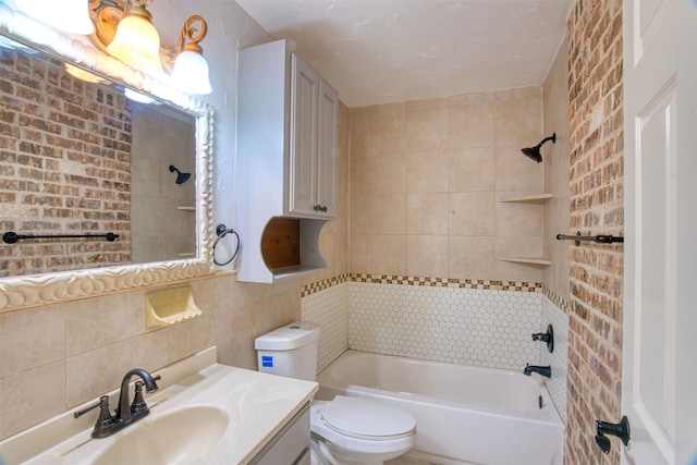 full bathroom featuring toilet, tiled shower / bath, backsplash, tile walls, and vanity