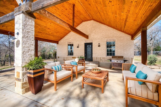 view of patio / terrace with exterior kitchen, an outdoor living space, and grilling area