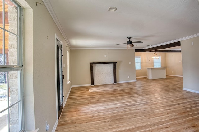 unfurnished living room featuring ceiling fan with notable chandelier, crown molding, and light wood-type flooring