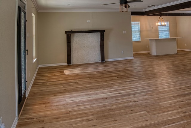 unfurnished living room with crown molding, ceiling fan with notable chandelier, and wood-type flooring