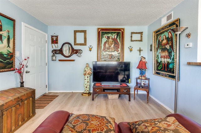 interior space with light hardwood / wood-style floors and a textured ceiling