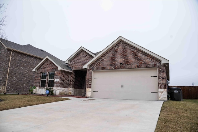 view of front of property with a garage and a front yard