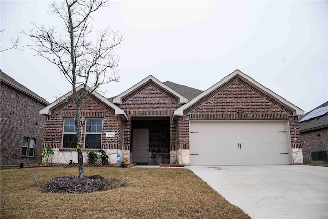 view of front of property with a garage, a front lawn, and cooling unit