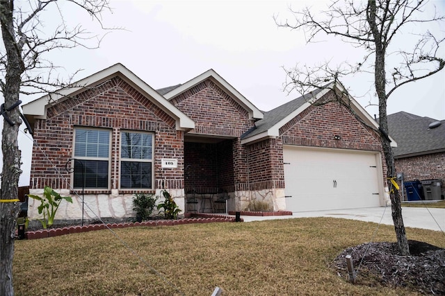 view of front of house featuring a garage and a front lawn