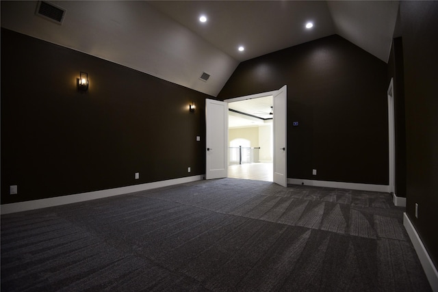 carpeted spare room with ceiling fan and lofted ceiling