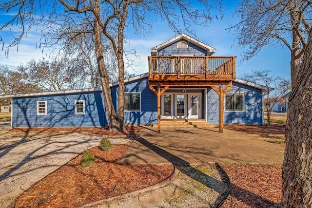 view of front property with a wooden deck and a patio area