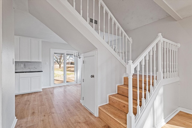 stairway featuring wood-type flooring