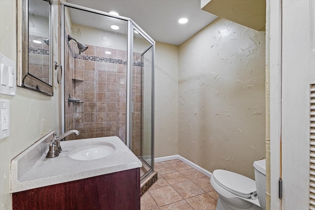 bathroom with an enclosed shower, vanity, tile patterned floors, and toilet