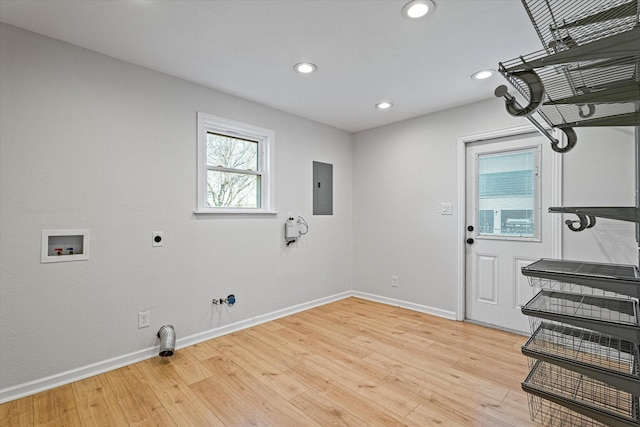 laundry room featuring washer hookup, electric panel, light hardwood / wood-style flooring, and electric dryer hookup