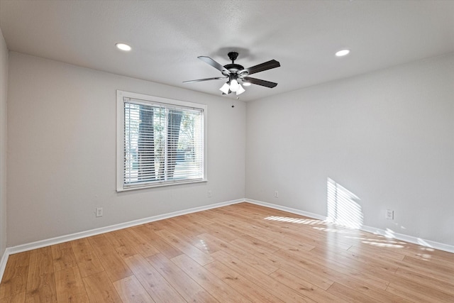 empty room featuring ceiling fan and light wood-type flooring