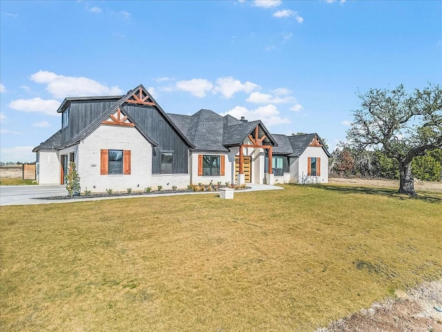 view of front of property with a garage and a front lawn