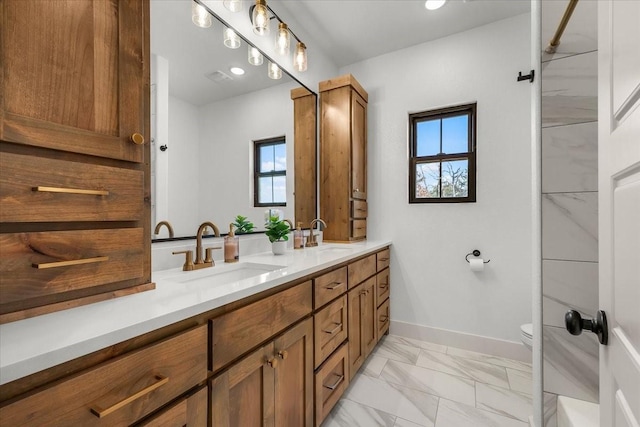 bathroom featuring vanity and toilet