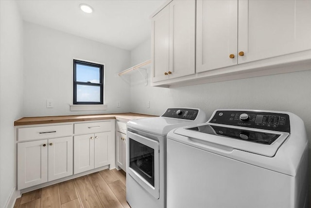 laundry room featuring cabinets and washing machine and dryer