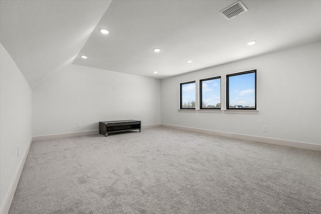 spare room featuring light colored carpet