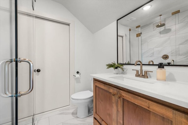 bathroom with vanity, toilet, a shower with door, and lofted ceiling