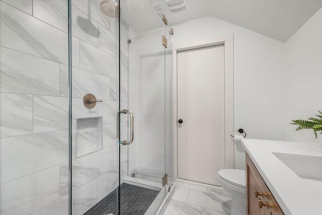 bathroom with vanity, toilet, and a shower with door