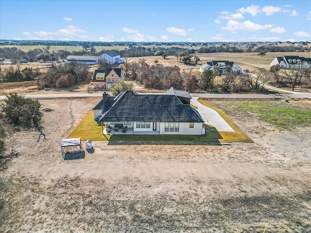 birds eye view of property with a rural view