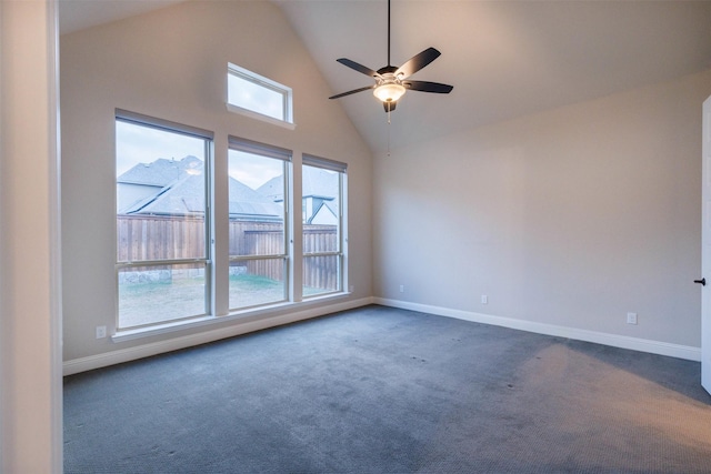 empty room featuring high vaulted ceiling, ceiling fan, a healthy amount of sunlight, and dark carpet