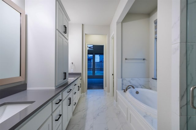 bathroom with vanity and independent shower and bath