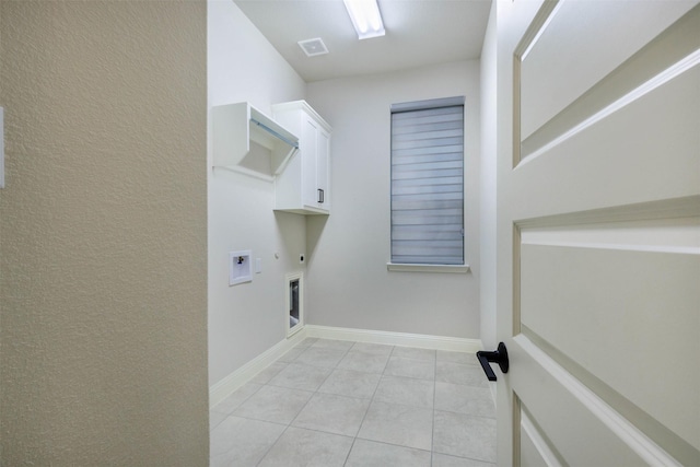 clothes washing area with light tile patterned flooring, cabinets, hookup for a washing machine, electric dryer hookup, and hookup for a gas dryer