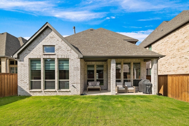 rear view of house with a lawn, outdoor lounge area, and a patio