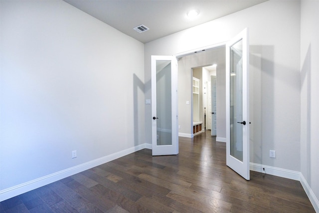 unfurnished room with dark hardwood / wood-style flooring and french doors