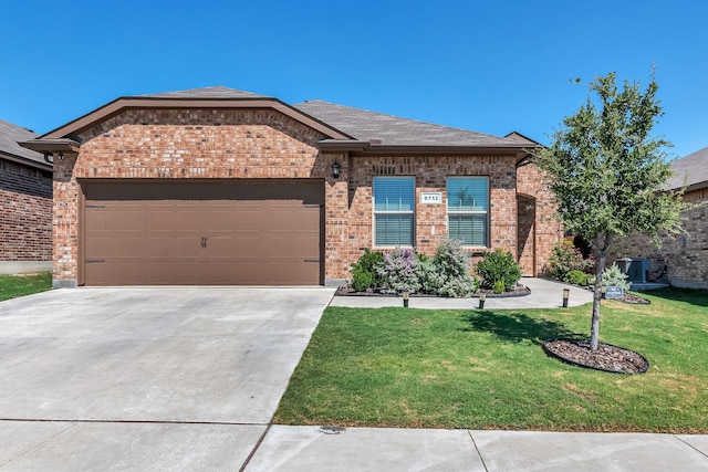 view of front of house with a garage and a front lawn