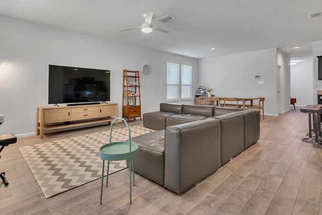 living room with ceiling fan and wood-type flooring