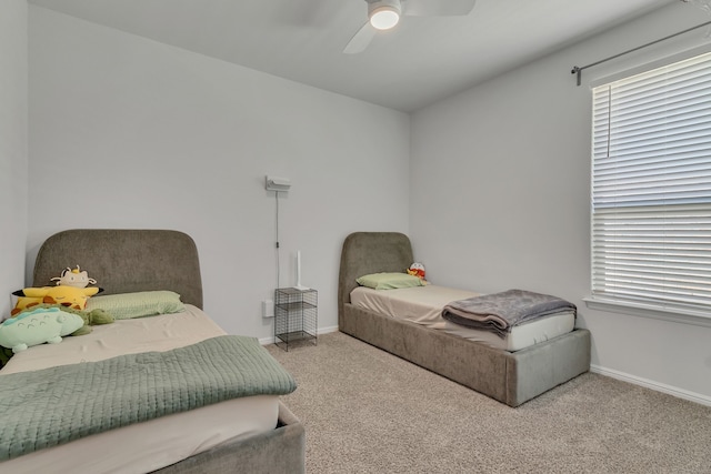 carpeted bedroom with multiple windows and ceiling fan