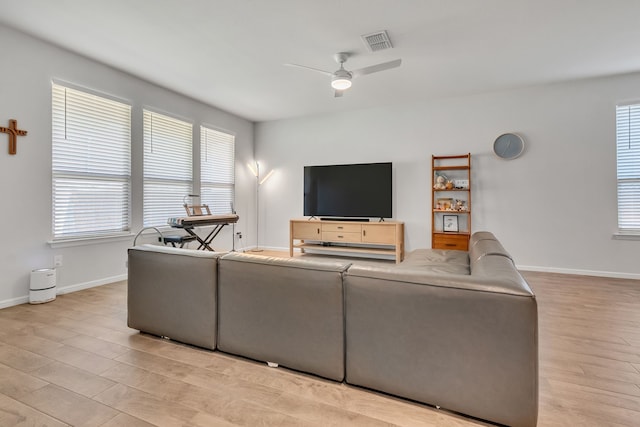 living room with ceiling fan and light hardwood / wood-style floors