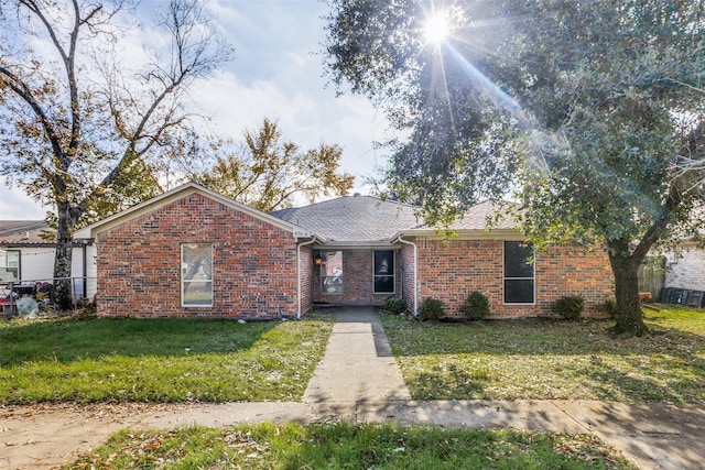 ranch-style home with a front lawn