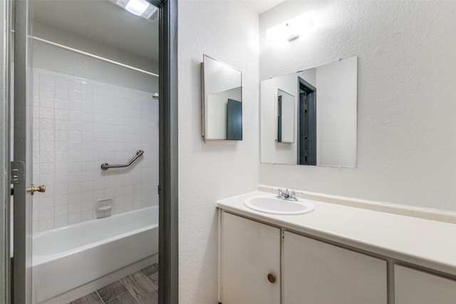 bathroom with vanity and tiled shower / bath combo