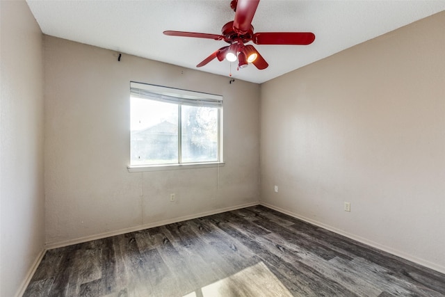 spare room featuring dark hardwood / wood-style floors and ceiling fan