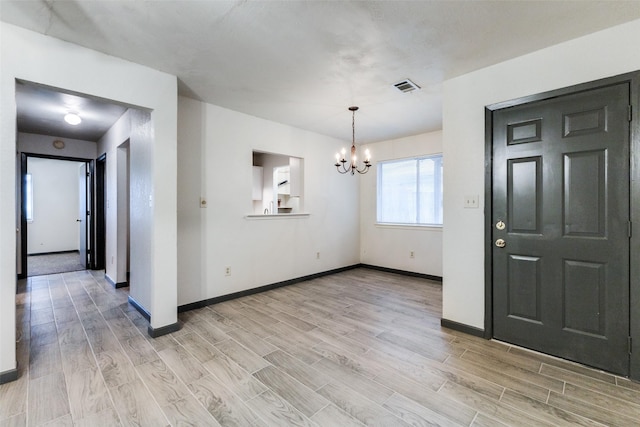 entrance foyer featuring an inviting chandelier