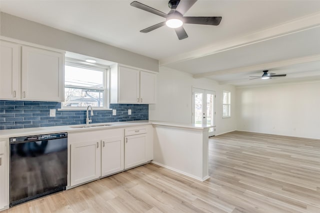 kitchen with a sink, open floor plan, light countertops, dishwasher, and light wood finished floors