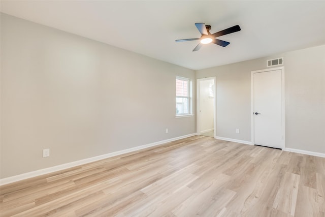 unfurnished room with visible vents, ceiling fan, light wood-style flooring, and baseboards