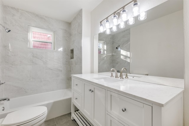 full bathroom with tile patterned flooring, vanity, tiled shower / bath combo, and toilet