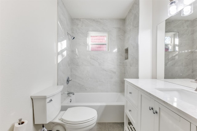 full bathroom featuring tile patterned flooring, vanity, toilet, and tiled shower / bath combo