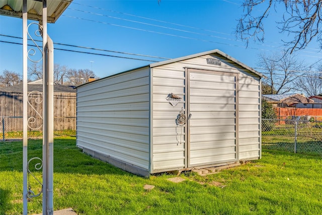 view of outdoor structure featuring a lawn