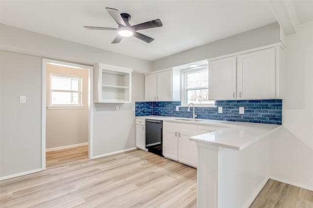 kitchen with sink, ceiling fan, black dishwasher, tasteful backsplash, and white cabinetry