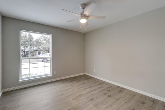 empty room with ceiling fan and light wood-type flooring