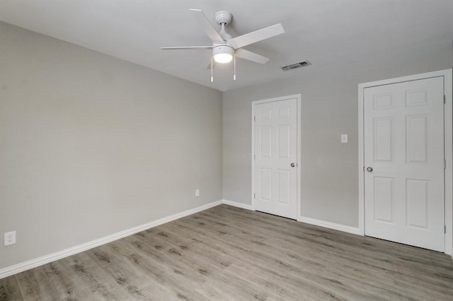 unfurnished bedroom featuring ceiling fan and light wood-type flooring