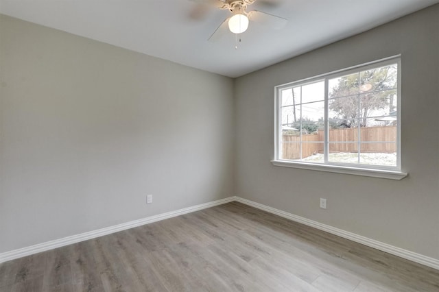 empty room featuring ceiling fan and light hardwood / wood-style floors