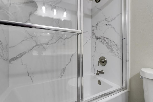 bathroom featuring shower / bath combination with glass door