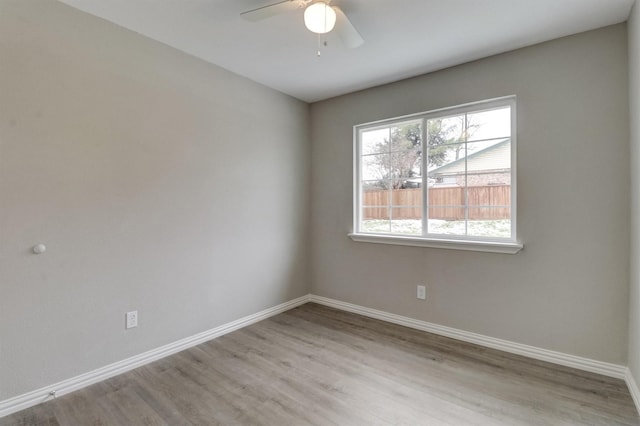 empty room with light hardwood / wood-style floors and ceiling fan